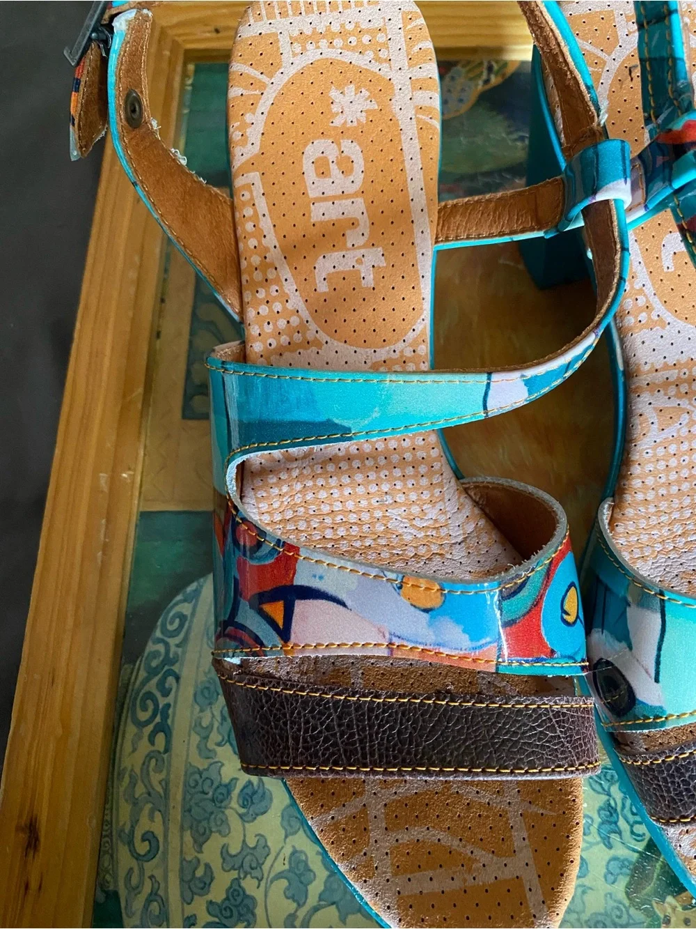 The Art Company, featuring a turquoise and multi-colored abstract pattern